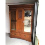 Art Nouveau mahogany wardrobe, with moulded cornice and twin mirrored doors between relief carved fo