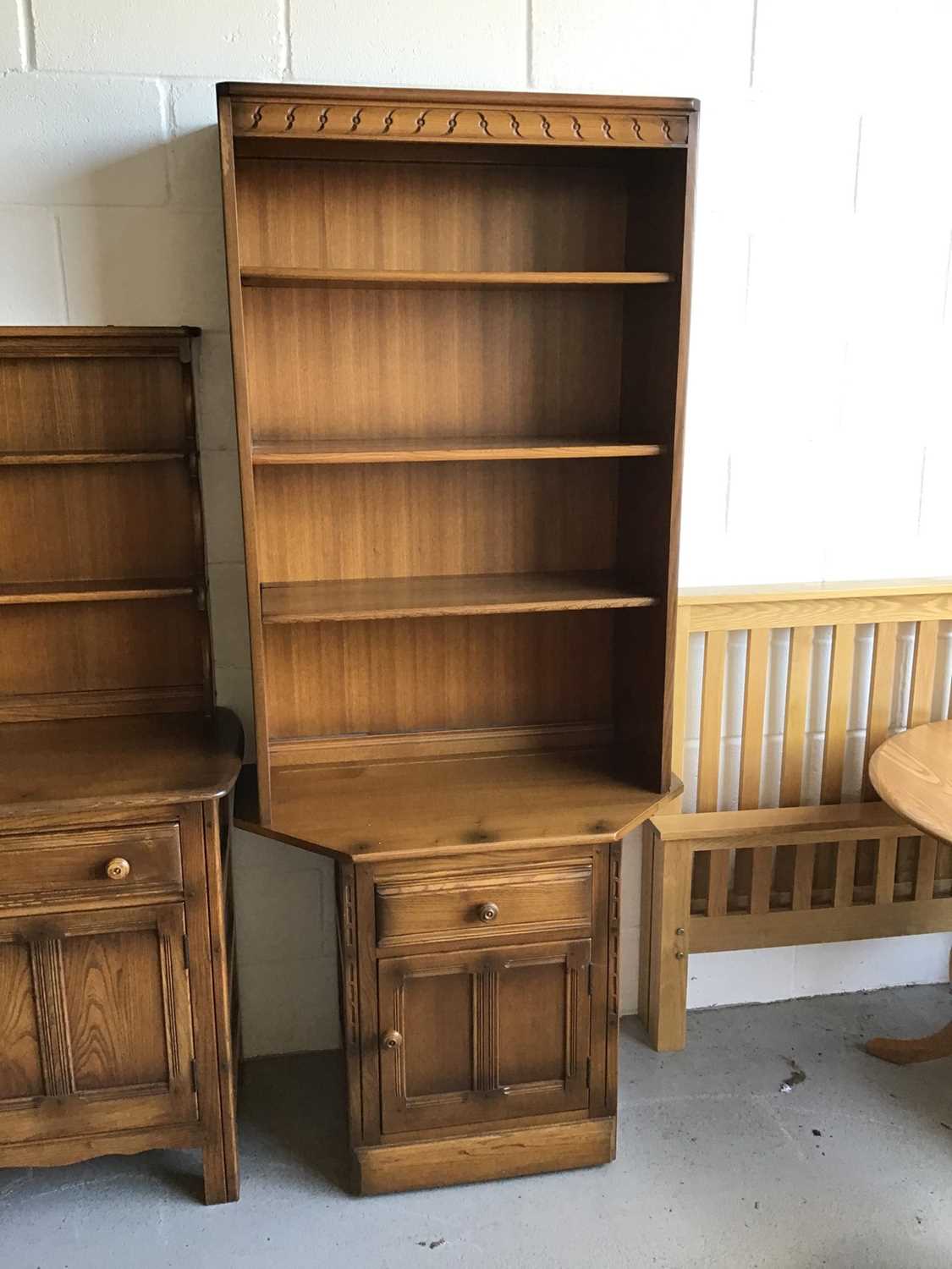 Ercol elm two height bookcase with three opened shelves above single drawer and cupboard below H196.