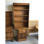 Ercol elm two height bookcase with three opened shelves above single drawer and cupboard below H196.
