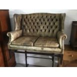 Good quality Georgian style green leather wing back two-seater settee with buttoned back, loose seat