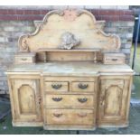 Pine sideboard, the arched gallery back with carved cresting and short drawers, breakfront base with