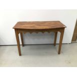 Old pine bow front side table with gothic arched frieze on square taper legs