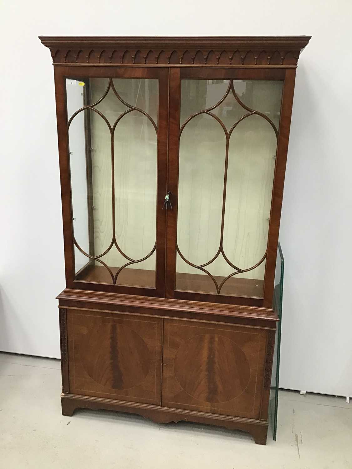 Good quality George III-style mahogany two height display cabinet, the top enclosed by gothic astrag