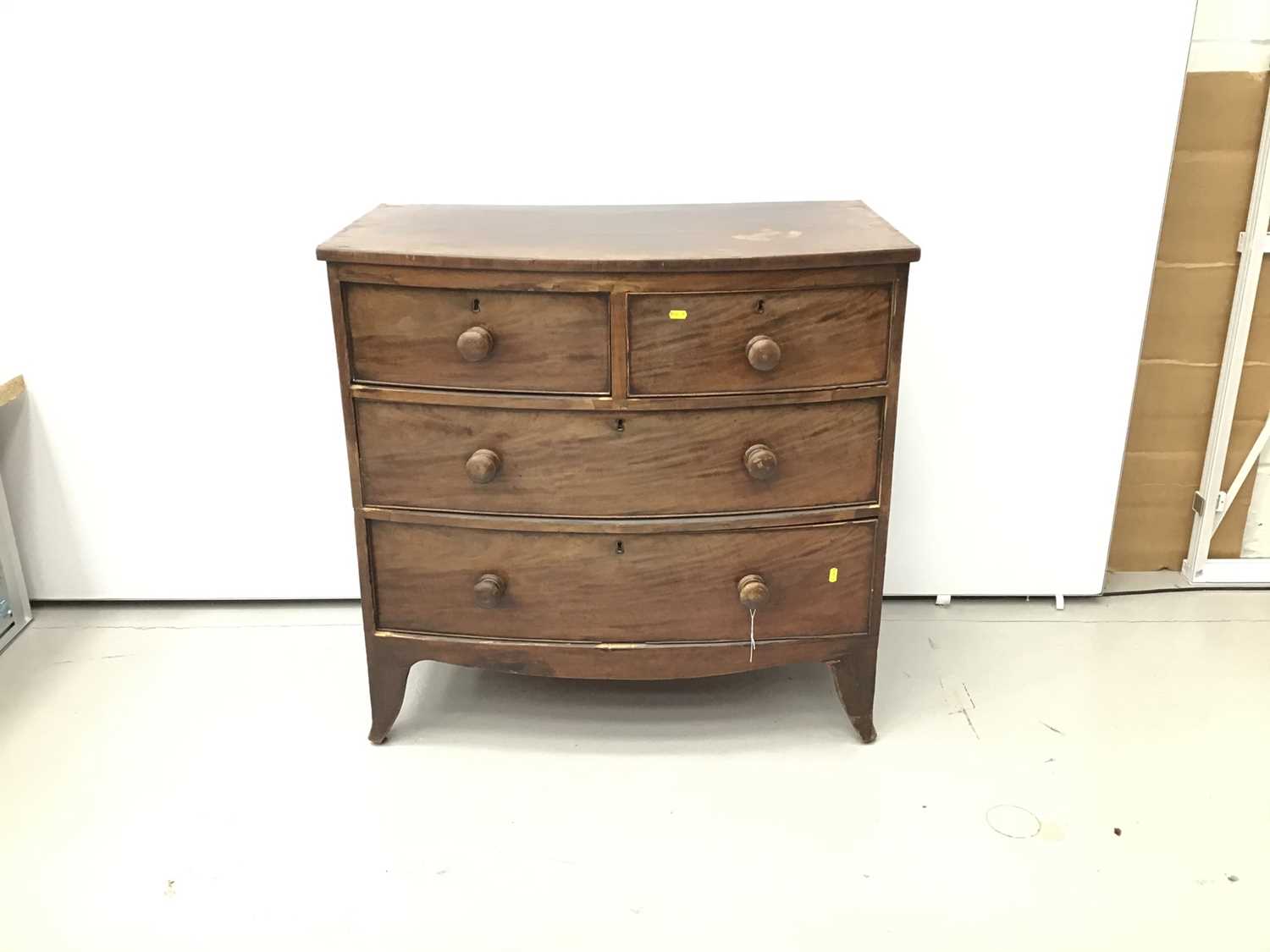 Small 19th century mahogany bow front chest of two short and two long drawers on splayed bracket fee