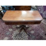 Regency mahogany card table with fold over top on carved and turned column and four splayed legs, 91