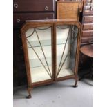 Art Deco walnut veneered display cabinet with glass shelves enclosed by two glazed doors 87cm wide x