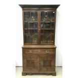 Edwardian oak two height secretaire bookcase with moulded cornice, adjustable wooden shelves enclose
