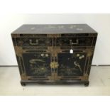 Chinese black lacquered cupboard with chinoiserie gilded decoration, two drawers and cupboards below