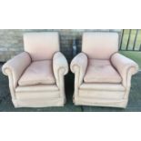 Pair of early 20th century deep upholstered easy chairs, raised on bun feet and castors