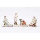 Four Staffordshire pearlware figures, c.1800, including two reclining figures, possibly representing