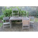Teak garden table together with set of six folding teak garden chairs