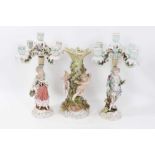 Pair of Continental porcelain figural candlesticks, similar table centre .