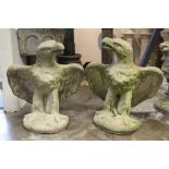 Pair of composition concrete statues of eagles, on circular plinth, 85cm high
