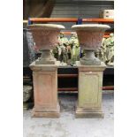Monumental pair of ceramic garden urns on plinths