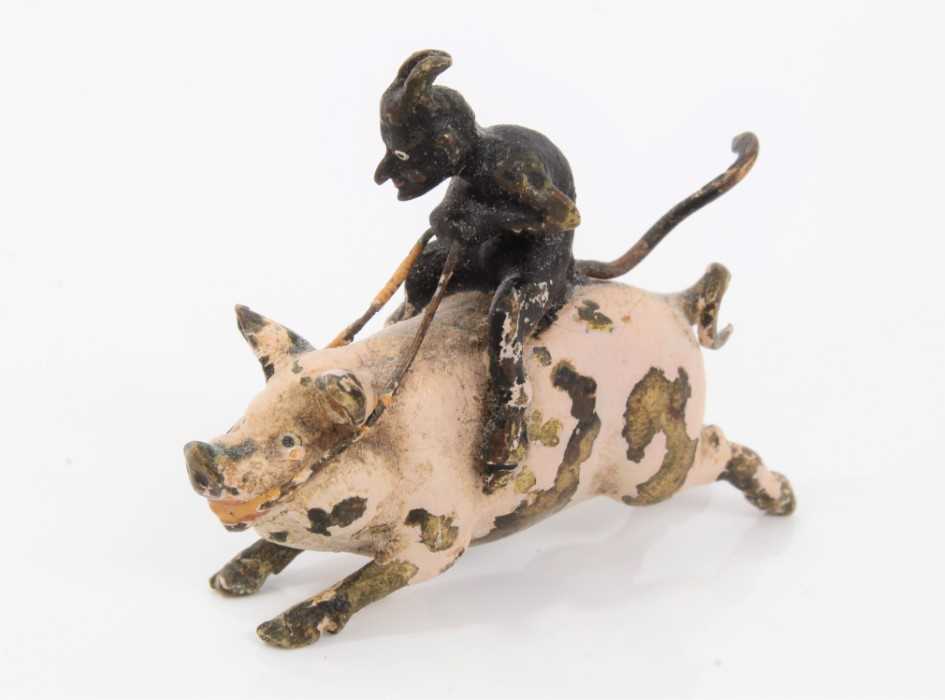 Novelty cold painted bronze model of a pig ridden by the devil