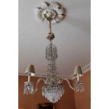 An impressive early 19th century cut glass three branch chandelier, converted to electricity