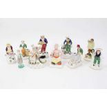 Collection of ten Staffordshire figures, including a Turk, a man pushing a wheelbarrow, etc, between