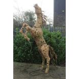 Very large patinated metal sculpture of a rearing horse, total height approximately 245cm