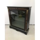 Victorian ebonised and gilt metal mounted pier cabinet, enclosed by glazed door on shaped plinth, 93