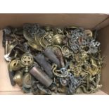 One box containing a quantity of antique brass furniture fittings