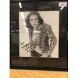 Signed portrait photograph of Elizabeth Hurley signed ' love Elizabeth Hurley ' in glazed frame