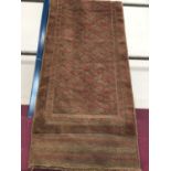 Pakistani runner with geometric decoration on brown and red ground 236cm x 63cm