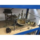 Pair of antique brass fire dogs, together with brass trivets and a group of copper and brass ladles