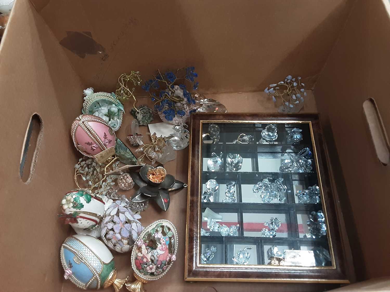 Two boxes of decorative items including eggs, Swarovski style glass ornaments and china