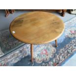 Ercol 'Golden Dawn' circular coffee table together with two Chinese rugs
