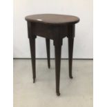 19th century mahogany side table/stool with circular top on tapered legs terminating on brass castor