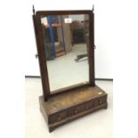 19th century mahogany toilet mirror with rectangular plate above rectangular plateau containing thre