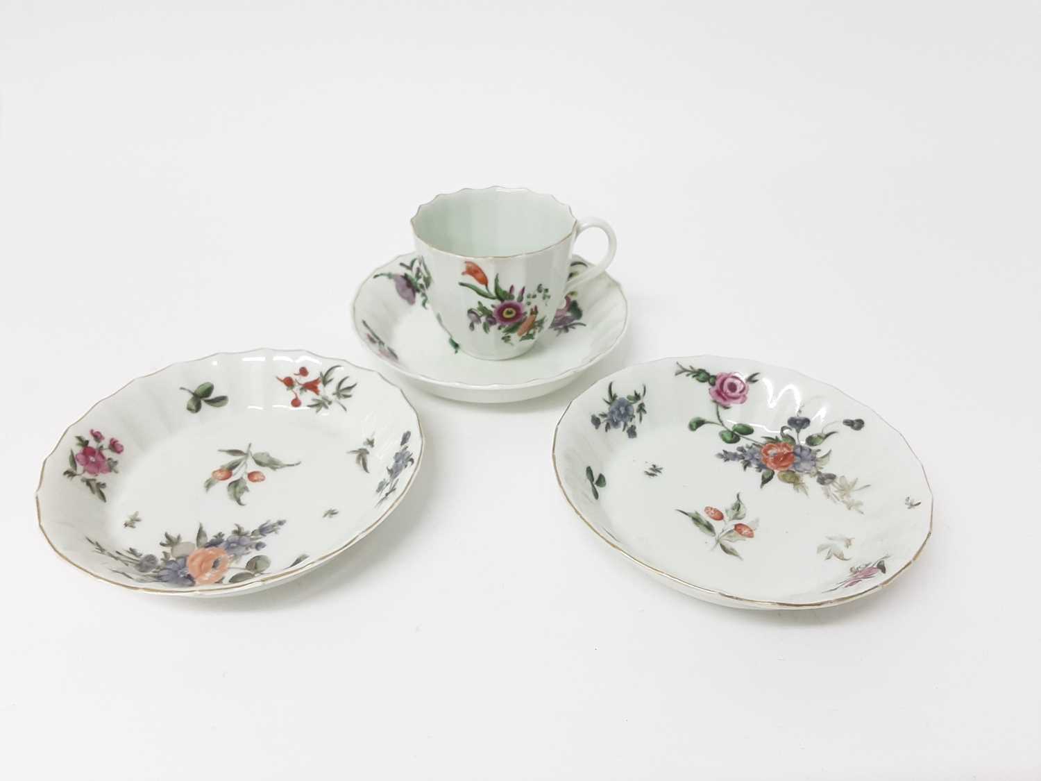 A Worcester flower painted faceted coffee cup and three saucers, circa 1770