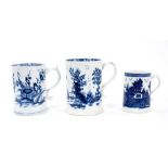 Lowestoft cylindrical mug, with a spreading foot and scrolled handle, boldly painted in blue with fl