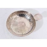 George V silver wine taster of circular form with chased decoration, the base set with an Elizabetha