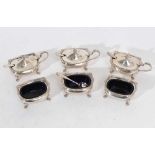 Three Elizabeth II silver mustard pots of cauldron form with gadrooned borders, domed hinged covers
