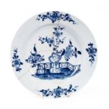 Lowestoft plate, painted in blue with a flowering plant and rockwork within a fenced enclosure, four