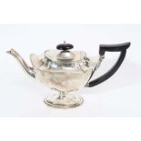 Victorian silver teapot of navette form with oval ebony finial and angular handle, raised on oval pe