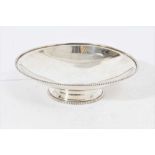 George VI silver dish of shallow circular form with beaded border, on splayed circular foot, also wi