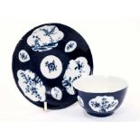 Good Lowestoft tea bowl and saucer, the powder blue ground with lobed panels of flowers and a Chinam