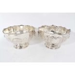 Pair of 20th Century silver plated punch bowls with embossed decoration, twin Lion mask handles and