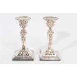 Pair of Elizabeth II silver Adam style candlesticks with tapered stems, urn shaped candle holders wi