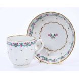 Lowestoft coffee cup and saucer, of faceted form with a scrolled handle, the centre in pink and gree