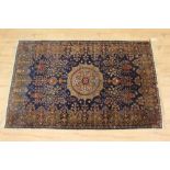 Part silk Kashan rug, with central medallion and floral vases on midnight blue ground main meander b