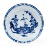 Lowestoft plate, painted in blue with a Chinese lady by a zig-zag fence and a large vase of flowers,