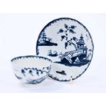 Lowestoft tea bowl and saucer, painted in blue with Chinese river landscapes and a berry border, sau
