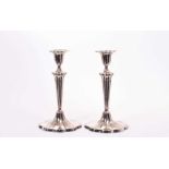 Pair of Edwardian silver candlesticks, with shaped tapering stems and inverted bell shaped candle ho
