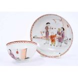 Lowestoft tea bowl and saucer, painted in the Mandarin style with three figures, one smoking a pipe,