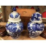 Pair of oriental blue and white urns and covers