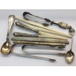 Pair silver sugar tongs, silver souvenir spoon, pair silver handled glove stretchers, two silver com