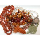 Group costume jewellery including amber and simulated amber beads, carnelian necklace, quartz pendan